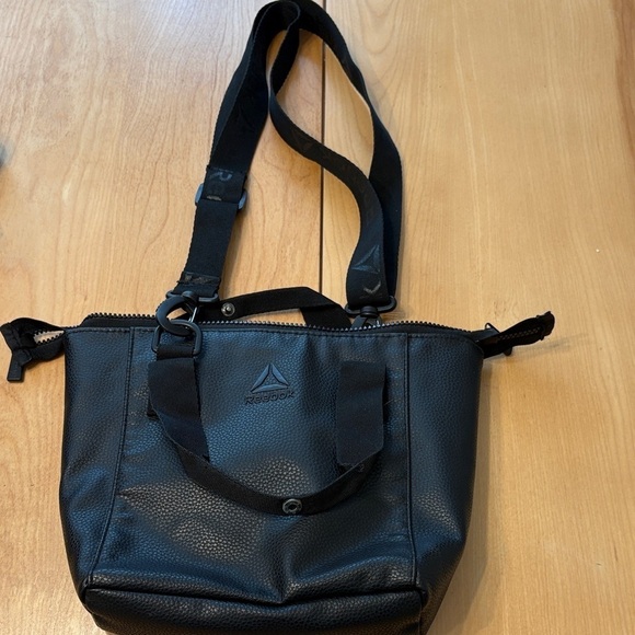 Reebok Handbags - Reebok Black Crossbody Bag for Women with removable strap and top handles.